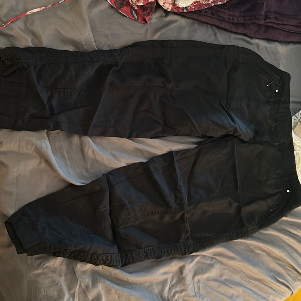Black pants, rayon and cotton.